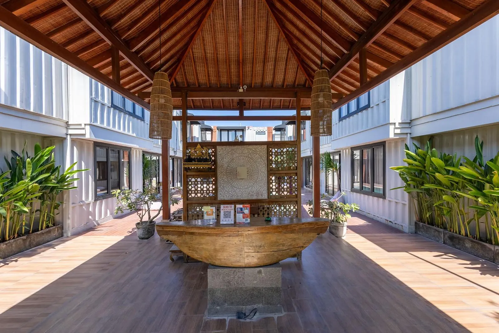 Inside the Balinese pavilion: a carved timber screen and a boat-shaped timber desk