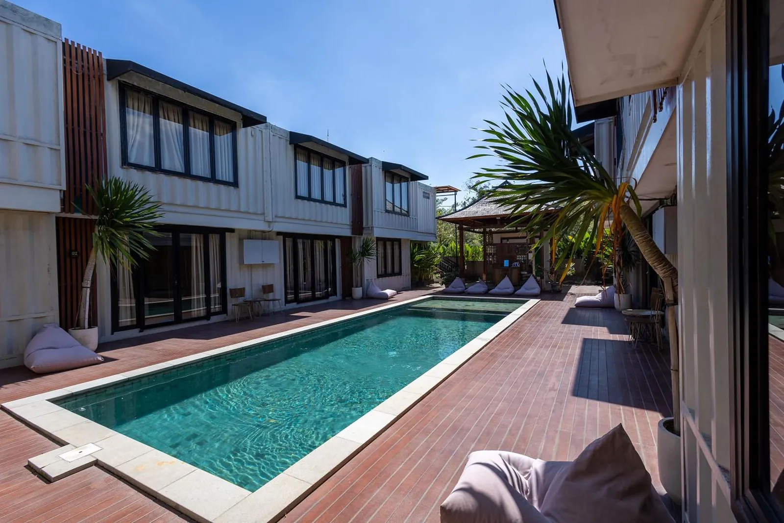 The pool and teak deck with the pavilion roof beyond the palms