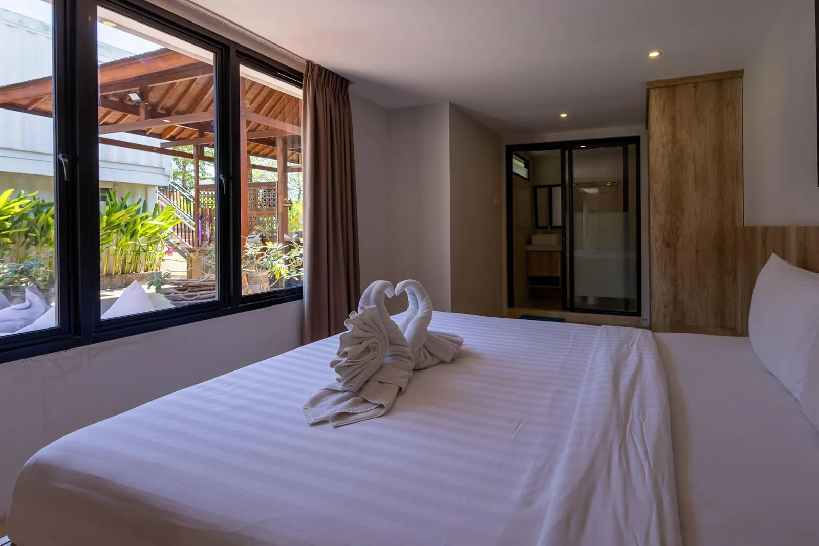 Pool-View Suite: bedroom window over the pavilion garden
